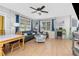 Bright living room with lots of natural light, wood floors, comfortable seating, and a ceiling fan at 7032 Duke St, Englewood, FL 34224