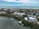 Coastal community with beachfront homes, tennis courts, and boats docked near a river at 7237 Rum Bay Dr # 5022, Placida, FL 33946