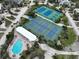 Aerial view of a community pool, hot tub, and tennis courts at 7237 Rum Bay Dr # 5022, Placida, FL 33946