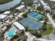 Aerial view of the tennis courts and pool in a waterfront community at 7237 Rum Bay Dr # 5022, Placida, FL 33946