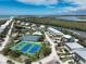 Aerial view of the community with tennis courts, pool, and waterfront homes at 7237 Rum Bay Dr # 5022, Placida, FL 33946