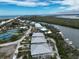 Coastal community with beachfront homes, tennis courts, a river, and boats docked along the shore at 7237 Rum Bay Dr # 5022, Placida, FL 33946