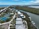 Scenic coastal community featuring beachfront homes, tennis courts, a river, and boats docked along the shore at 7237 Rum Bay Dr # 5022, Placida, FL 33946