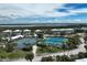 Wide aerial perspective capturing community amenities with tennis courts, pool, and waterfront homes at 7237 Rum Bay Dr # 5022, Placida, FL 33946