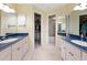 Bright bathroom featuring dual sinks, ample counter space, and separate access to closets at 7237 Rum Bay Dr # 5022, Placida, FL 33946