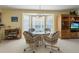Cozy dining area with a glass table, bay window, and comfortable wicker chairs at 7237 Rum Bay Dr # 5022, Placida, FL 33946