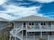 Modern condo building with staircases and balconies, set against a bright sky at 7237 Rum Bay Dr # 5022, Placida, FL 33946