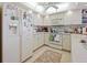 Well-lit kitchen featuring white cabinetry, a full-sized refrigerator, and modern appliances at 7237 Rum Bay Dr # 5022, Placida, FL 33946