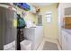 Functional laundry room with a washing machine, storage, and water heater at 7237 Rum Bay Dr # 5022, Placida, FL 33946
