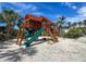 A wooden playground with a slide and climbing structure, perfect for outdoor fun at 7237 Rum Bay Dr # 5022, Placida, FL 33946