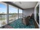 Relaxing screened-in porch with stylish wicker furniture and a vibrant floral rug at 7237 Rum Bay Dr # 5022, Placida, FL 33946