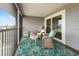 Relaxing screened-in porch with stylish wicker furniture and a vibrant floral rug at 7237 Rum Bay Dr # 5022, Placida, FL 33946