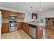 Bright kitchen features stainless steel appliances, wood cabinetry, and granite countertops at 7305 Innsbrook St, Englewood, FL 34224