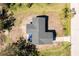 Birds eye view of single Gathering home with outdoor patio set and view of surrounding greenery at 8159 Archie St, Englewood, FL 34224