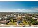 Aerial view features the home nestled within a waterfront community near a bay at 8159 Archie St, Englewood, FL 34224