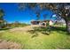 Expansive backyard featuring a screened-in lanai and well-maintained lawn at 8159 Archie St, Englewood, FL 34224