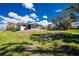 Expansive backyard view showcases the home's outdoor space and screened porch at 8159 Archie St, Englewood, FL 34224