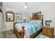 Comfortable bedroom with wooden furniture, nautical decor, and a ceiling fan at 8159 Archie St, Englewood, FL 34224