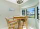 Bright breakfast nook featuring a round table, wicker chairs, and a bay window with a view at 8159 Archie St, Englewood, FL 34224