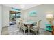 Cozy dining area with seating for six, complemented by natural light and serene decor at 8159 Archie St, Englewood, FL 34224