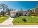 Charming single-story home featuring a well-manicured lawn and an attached garage at 8159 Archie St, Englewood, FL 34224