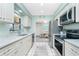 Functional kitchen design featuring stainless steel appliances, a stylish backsplash, and a well-lit workspace at 8159 Archie St, Englewood, FL 34224