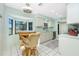 Well-lit kitchen features white cabinetry, stainless steel appliances, and a breakfast nook with a bay window at 8159 Archie St, Englewood, FL 34224
