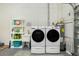 Washer and dryer setup near a deep utility sink in a finished garage at 8159 Archie St, Englewood, FL 34224