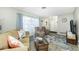 Bright living room with a large window, plush seating, and a stylish coffee table at 8159 Archie St, Englewood, FL 34224