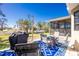 Outdoor patio includes four chairs and a built-in fire pit area and grill at 8159 Archie St, Englewood, FL 34224