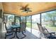 Screened in lanai features a tile floor, wood ceiling, and relaxing seating area at 8159 Archie St, Englewood, FL 34224