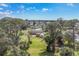 Aerial view showcasing a home with a large, well-maintained backyard with two storage buildings at 840 E 7Th St, Englewood, FL 34223