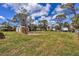 Wide open backyard with green grass and shed at 840 E 7Th St, Englewood, FL 34223