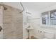 Bright bathroom featuring a tiled walk-in shower and pedestal sink at 840 E 7Th St, Englewood, FL 34223