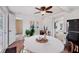 Cozy dining area with a round table, ceiling fan, and views into the kitchen at 840 E 7Th St, Englewood, FL 34223
