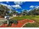 Landscaped front yard with vibrant plants and rock borders enhances this home's curb appeal at 840 E 7Th St, Englewood, FL 34223