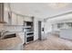 This kitchen has stainless steel appliances, gray cabinets and a tiled backsplash at 840 E 7Th St, Englewood, FL 34223