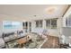 Bright living room featuring a comfortable sofa, stylish rug, and plenty of natural light at 840 E 7Th St, Englewood, FL 34223