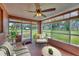 Relaxing sunroom with comfortable seating and views of the expansive backyard at 840 E 7Th St, Englewood, FL 34223