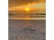 Beautiful beach sunset with golden light reflecting on the calm ocean and sandy shore at 8409 Placida Rd # 307, Placida, FL 33946