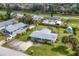 Charming home with lush landscaping, a gray roof, and a spacious driveway at 849 Palmetto St, Englewood, FL 34223