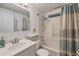 Bright bathroom featuring a shower-tub combo and a vanity with an undermount sink at 849 Palmetto St, Englewood, FL 34223