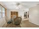 Comfortable dining room featuring wicker chairs, a glass table, and a view into the kitchen area at 849 Palmetto St, Englewood, FL 34223