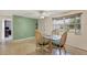 Bright dining area featuring casual seating, a ceiling fan, and natural light from the large window at 849 Palmetto St, Englewood, FL 34223