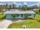 Aerial front view of single-Gathering home with pristine lawn and mature landscaping at 849 Palmetto St, Englewood, FL 34223