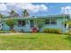 Charming single-Gathering home with a lush lawn, a dolphin ornament and vibrant landscaping at 849 Palmetto St, Englewood, FL 34223