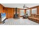 The cozy living room is equipped with a brick fireplace and paneled walls, perfect for chilly evenings at 849 Palmetto St, Englewood, FL 34223