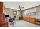 Office space featuring wood paneling, two windows, and ceiling fan at 849 Palmetto St, Englewood, FL 34223