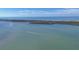 Scenic aerial view of the ocean, coastline, islands, and a boat trail at 9203 Griggs Rd # 204, Englewood, FL 34224