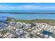 Breathtaking aerial view highlighting the waterfront community, serene surroundings, and multiple building structures at 9203 Griggs Rd # 204, Englewood, FL 34224